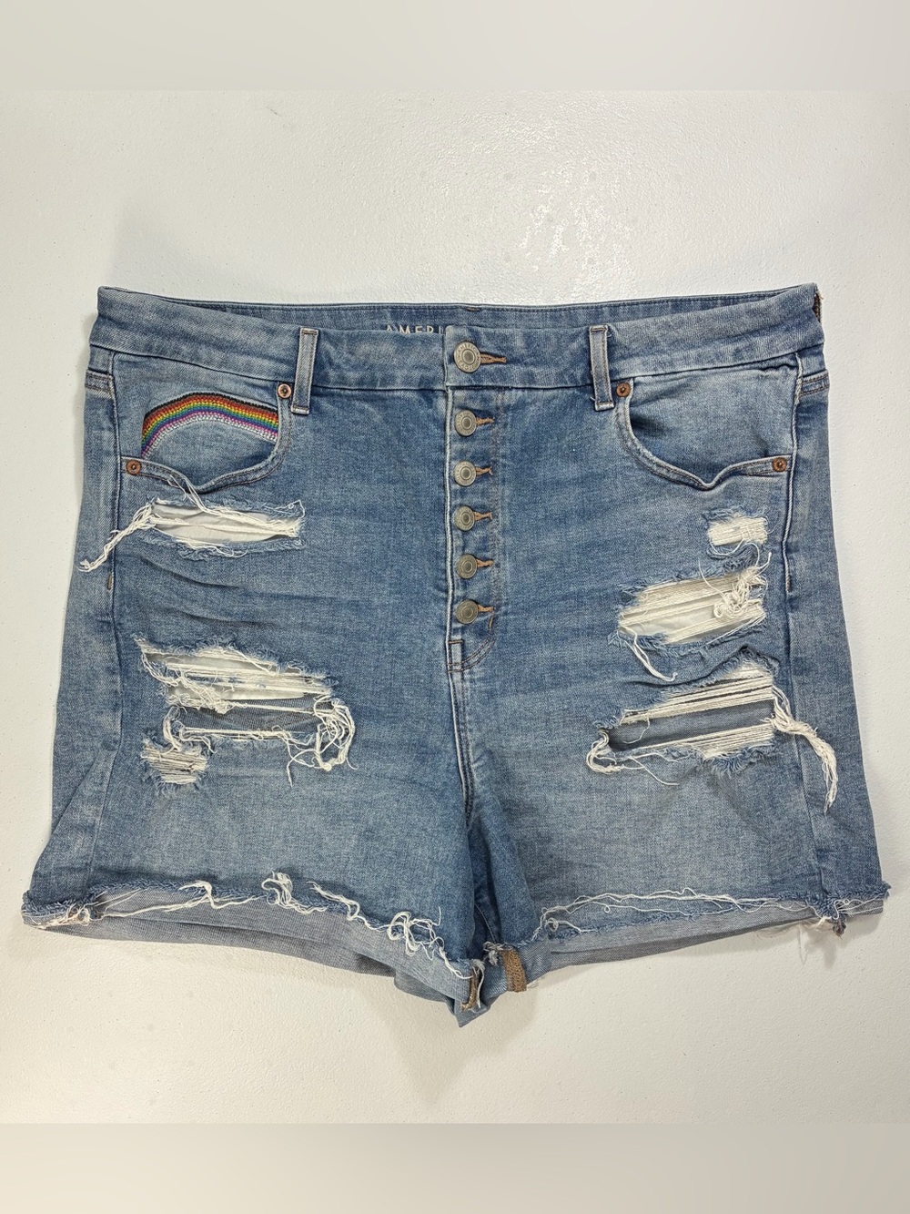 High-Rise Distressed Denim Shorts in Light Blue